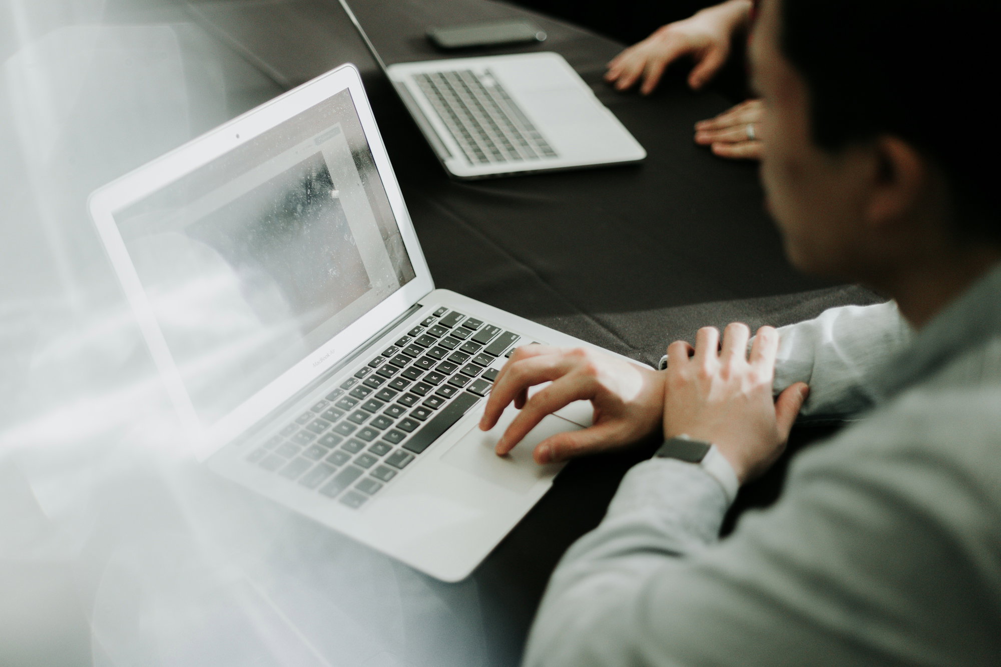 a-man-sitting-in-front-of-a-laptop-computer.jpg a man sitting in front of a laptop computer