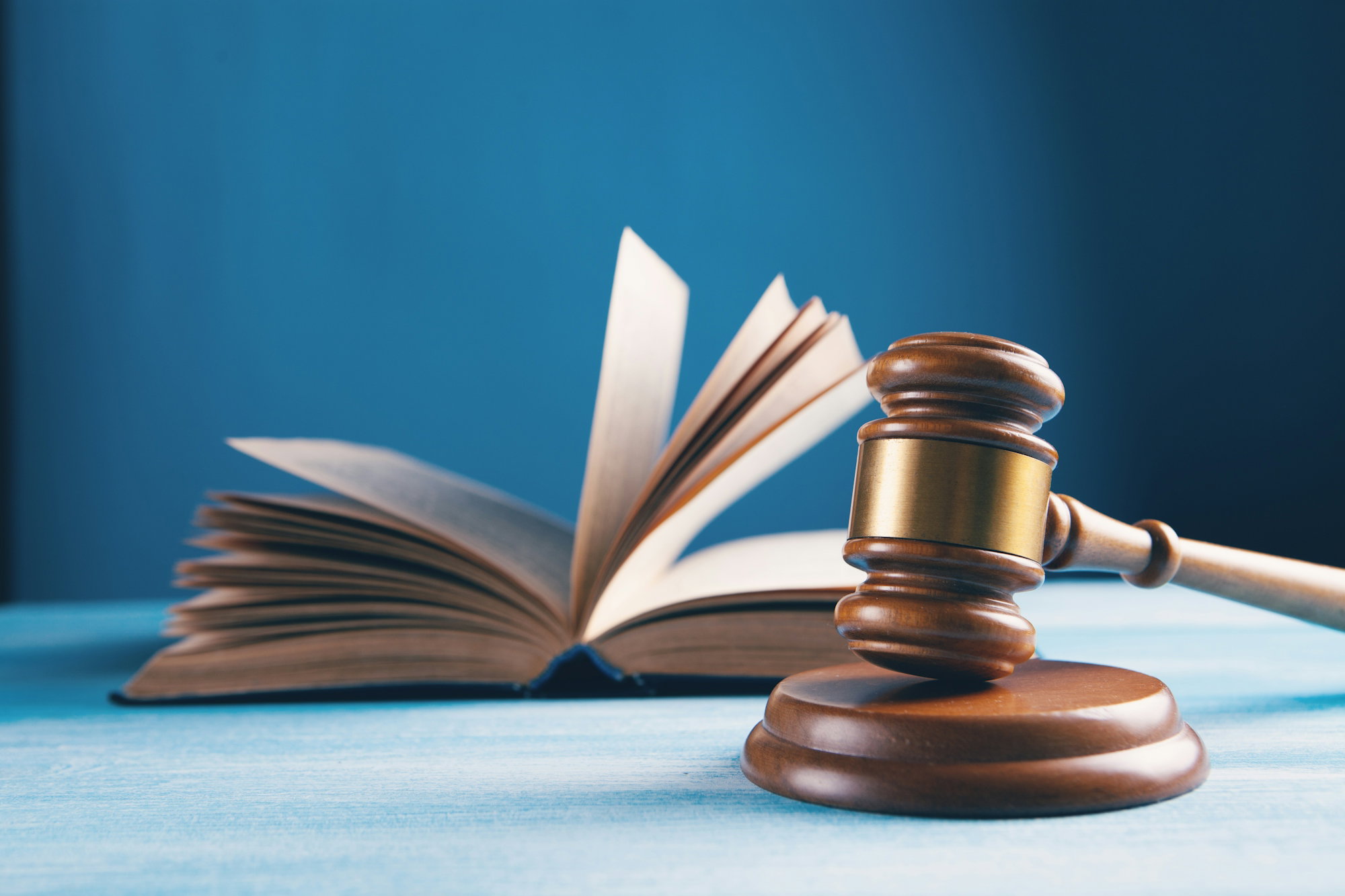judges-gavel-and-open-book-on-table.jpg judges gavel and open book on table